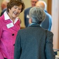 Joan Secchia speaking with a guest